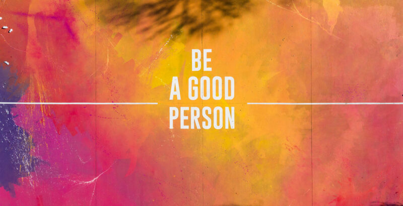 Farbiges Banner in Orange- und Pinktönen mit dem Schriftzug ‚Be a good person‘.