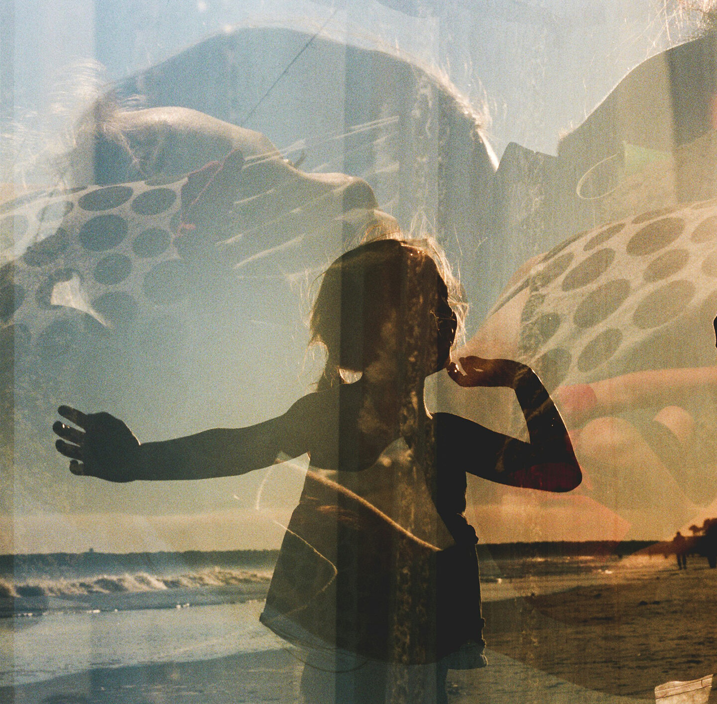 Mehrfachbelichtetes Bild: Silhouette ein Kind mit ausgebreiteten Armen vor Landschaft mit Himmel und Wasser; darübergelegt sind weitere halbtransparente Strukturen und runde Muster.